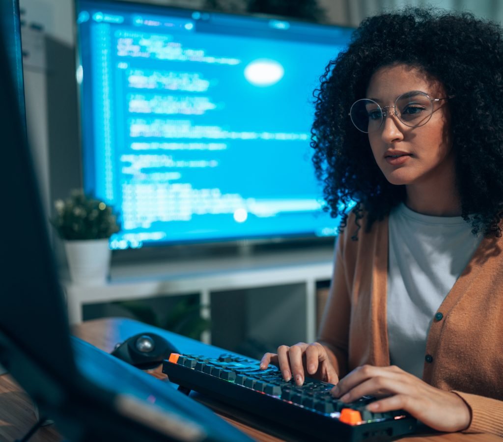 Young Hispanicfemale software developer coding on computer