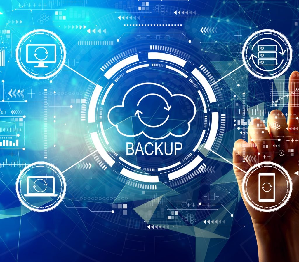 Backup concept with hand pressing a button on a technology screen