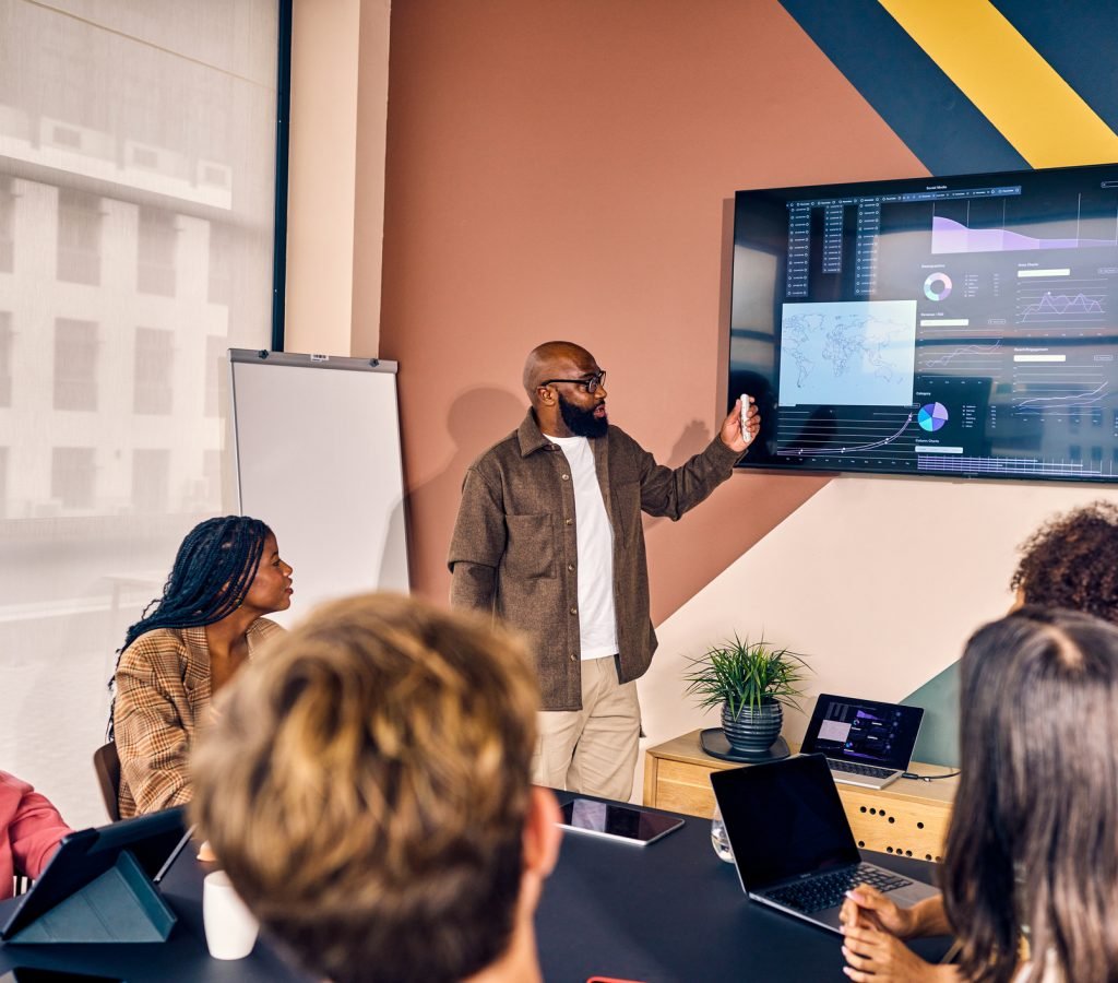 Multiracial business team in a meeting with data analysis presentation in a modern office. Corporate strategy and analytics concept