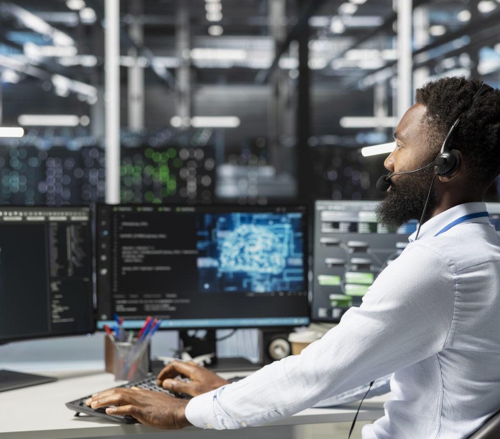 Employee talking in headset mic with technicians setting up data center equipment needed to run artificial intelligence. Server room worker in remote call with engineers installing AI tools