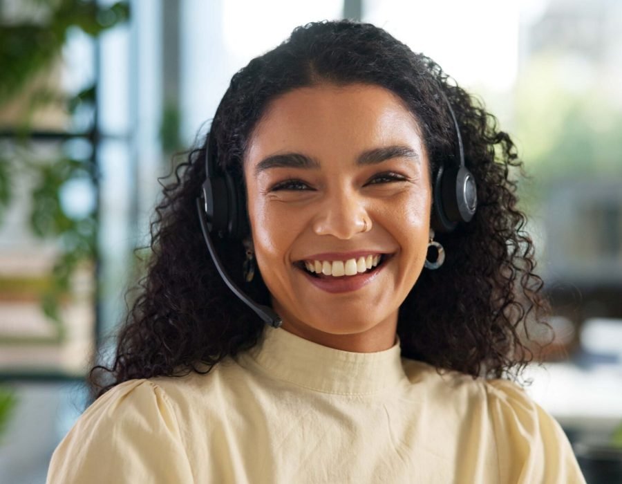 Agent, happy woman and customer service in portrait with smile, communication and online consulting. Sales, confident consultant and call center office for CRM contact support, advice or business